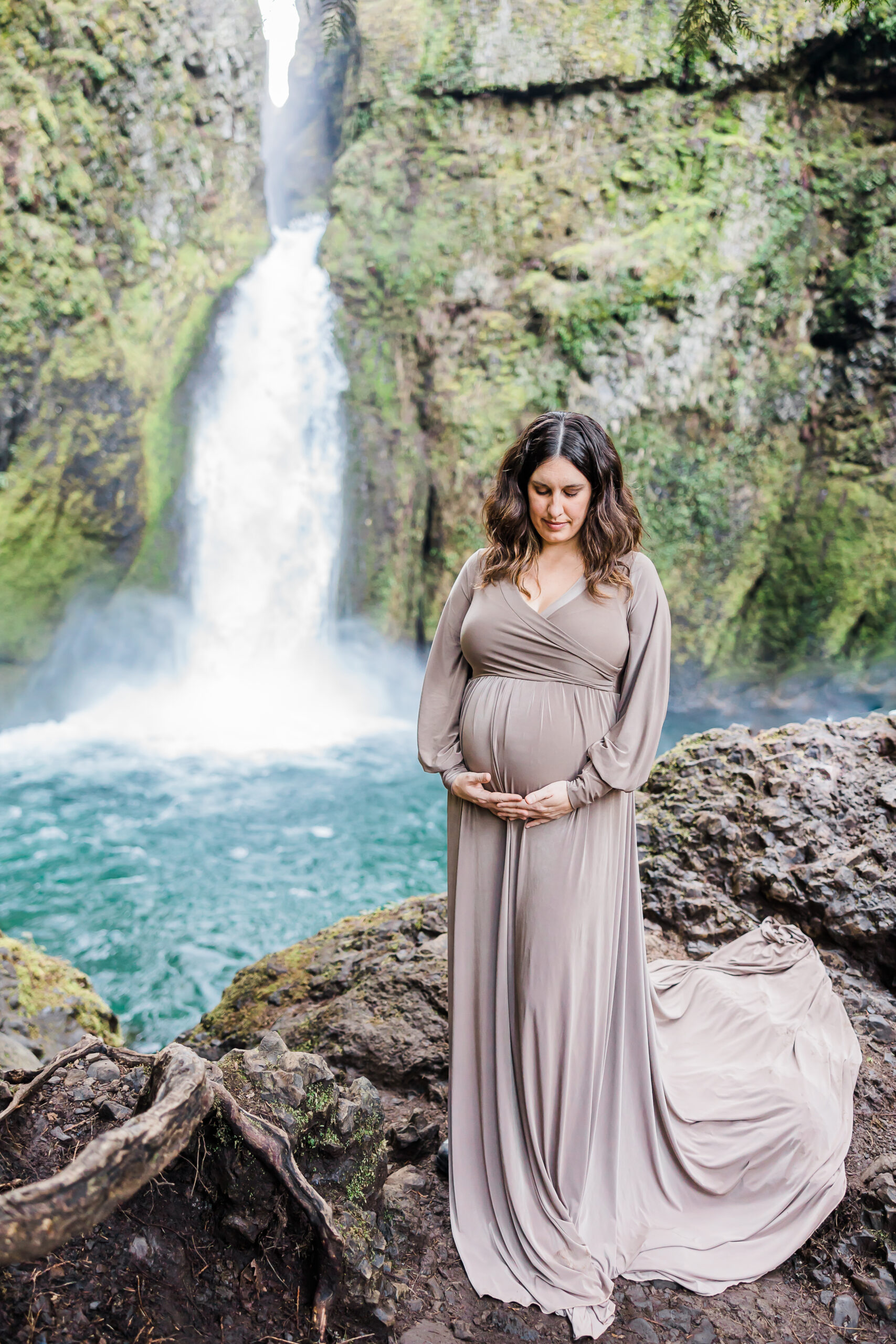 mom to be at a waterfall in a purple gown Le D Bug Boutique