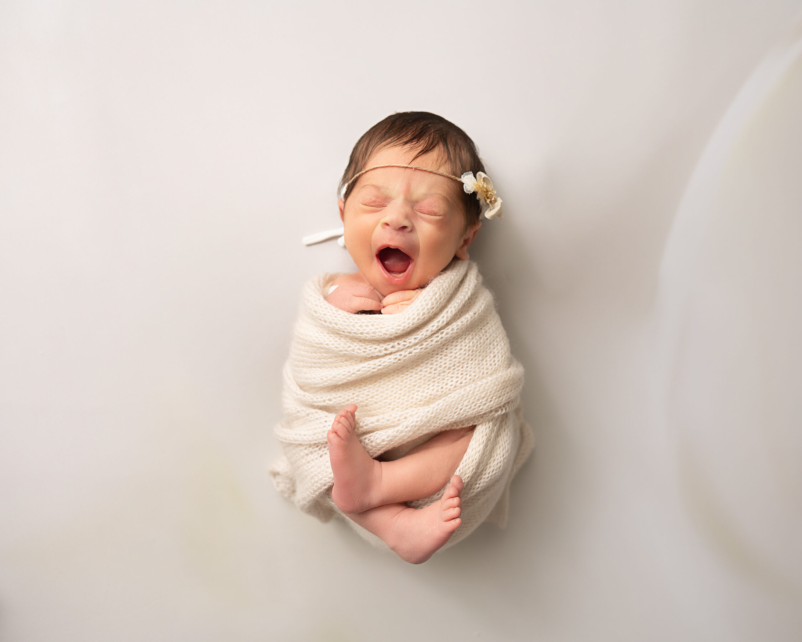 wrapped newborn yawning