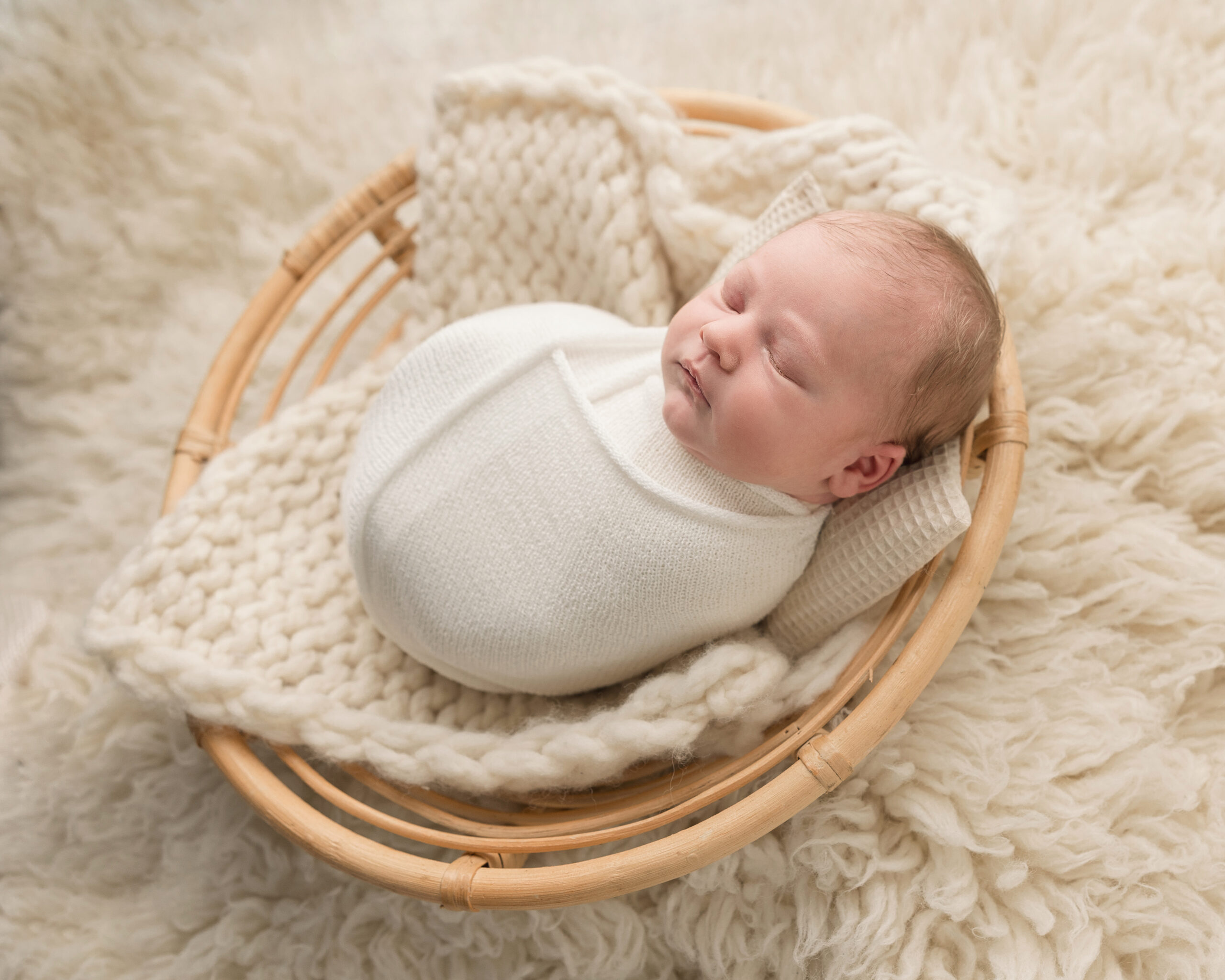 wrapped newborn baby boy in a basket baby wit boutique