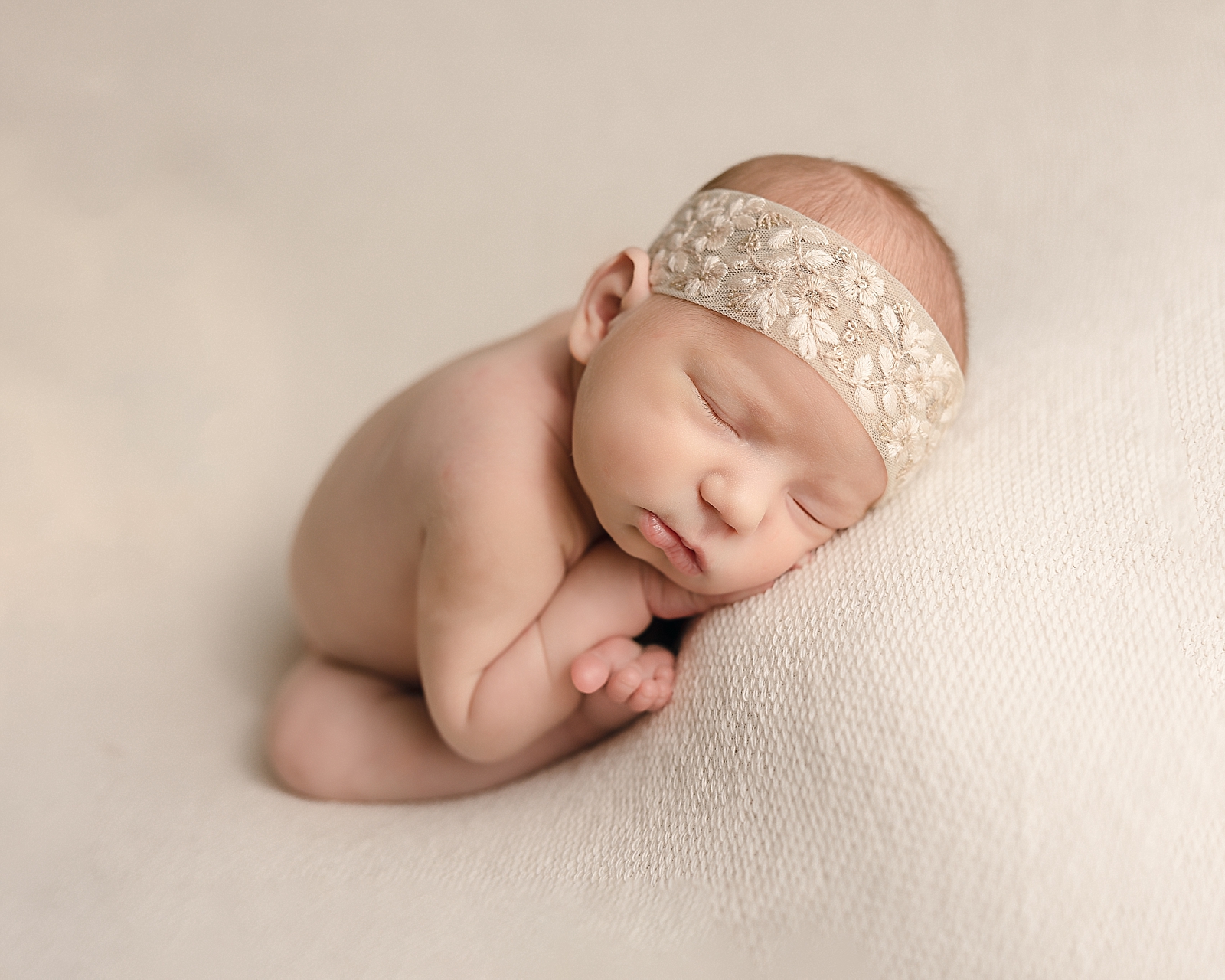 Newborn baby girl in a neutral headband OHSU Birthing Center