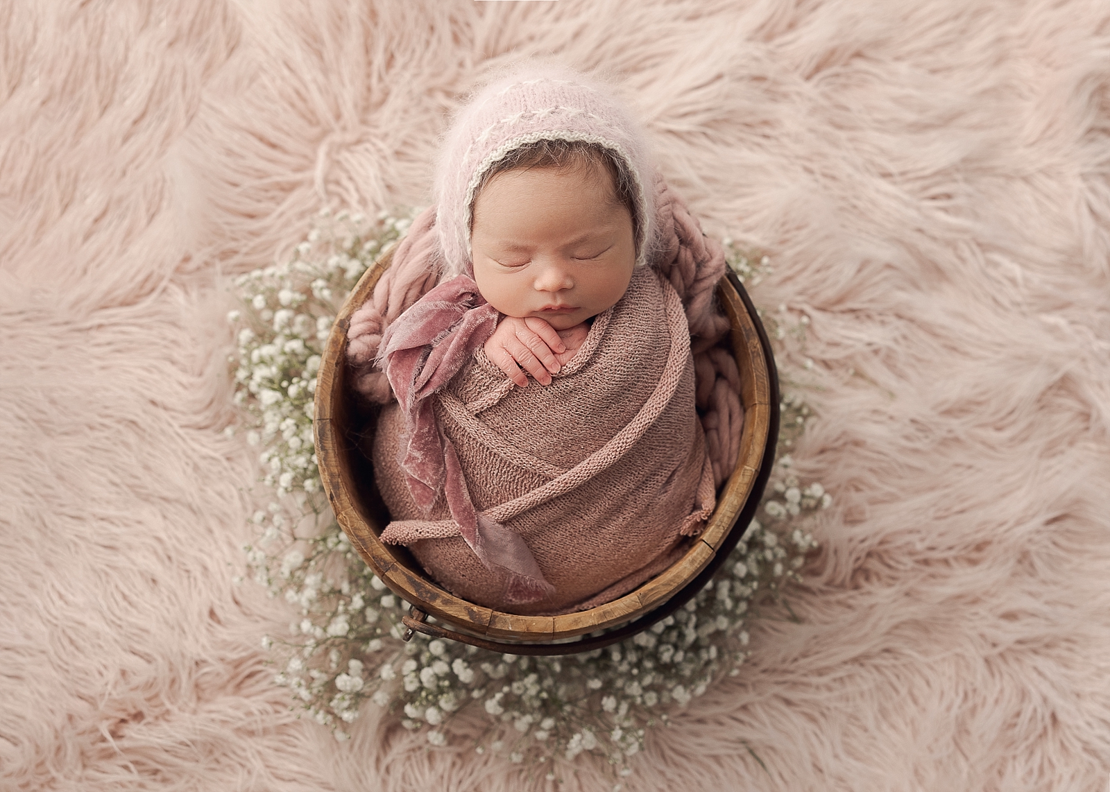 newborn baby wrapped in brown clothing sitting in a basket Bridgetown Baby