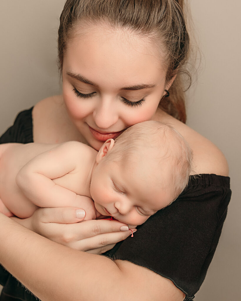 new mom holding her newborn baby in her arms Portland Doula Love