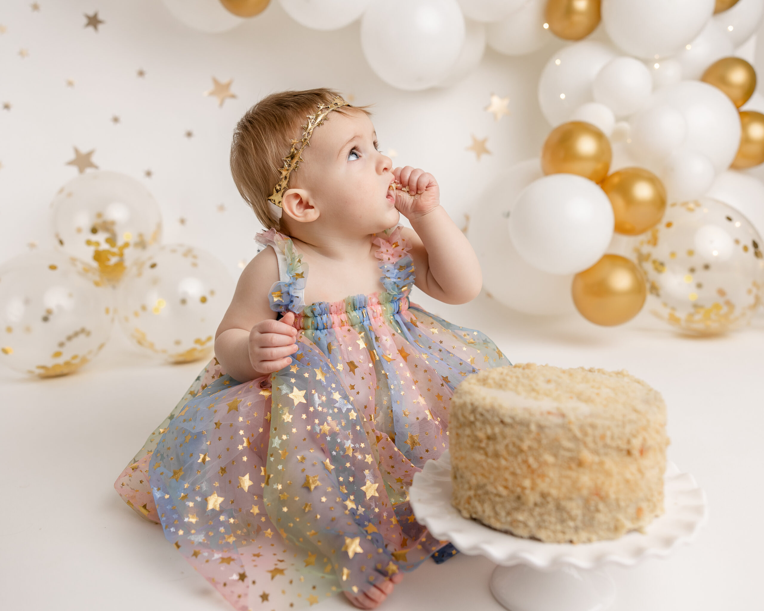 little girl in gold and blue dress celebrating her birthday Oodles of Toys