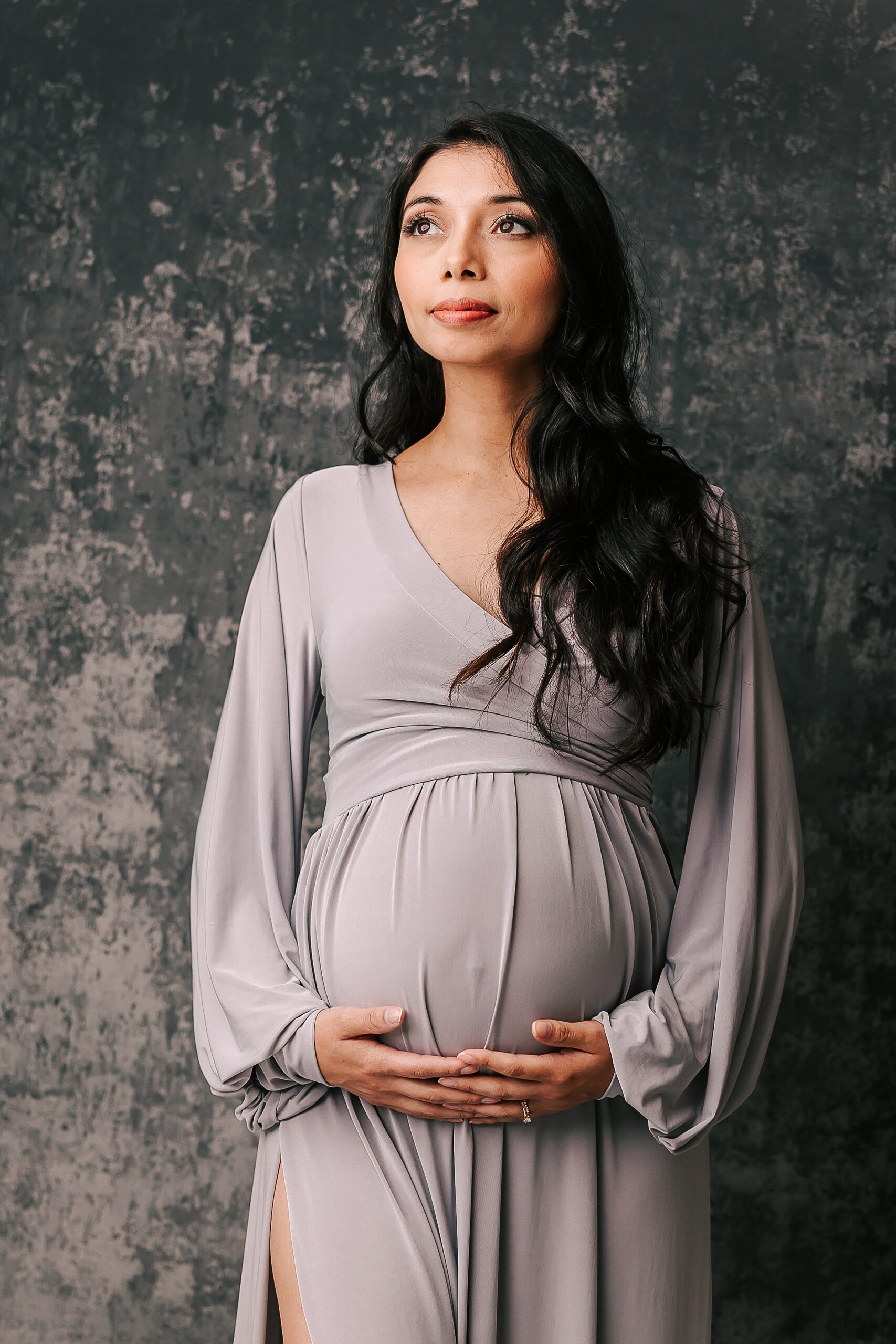 woman in lilac maternity gown holding her baby bump Motherseed Midwifery