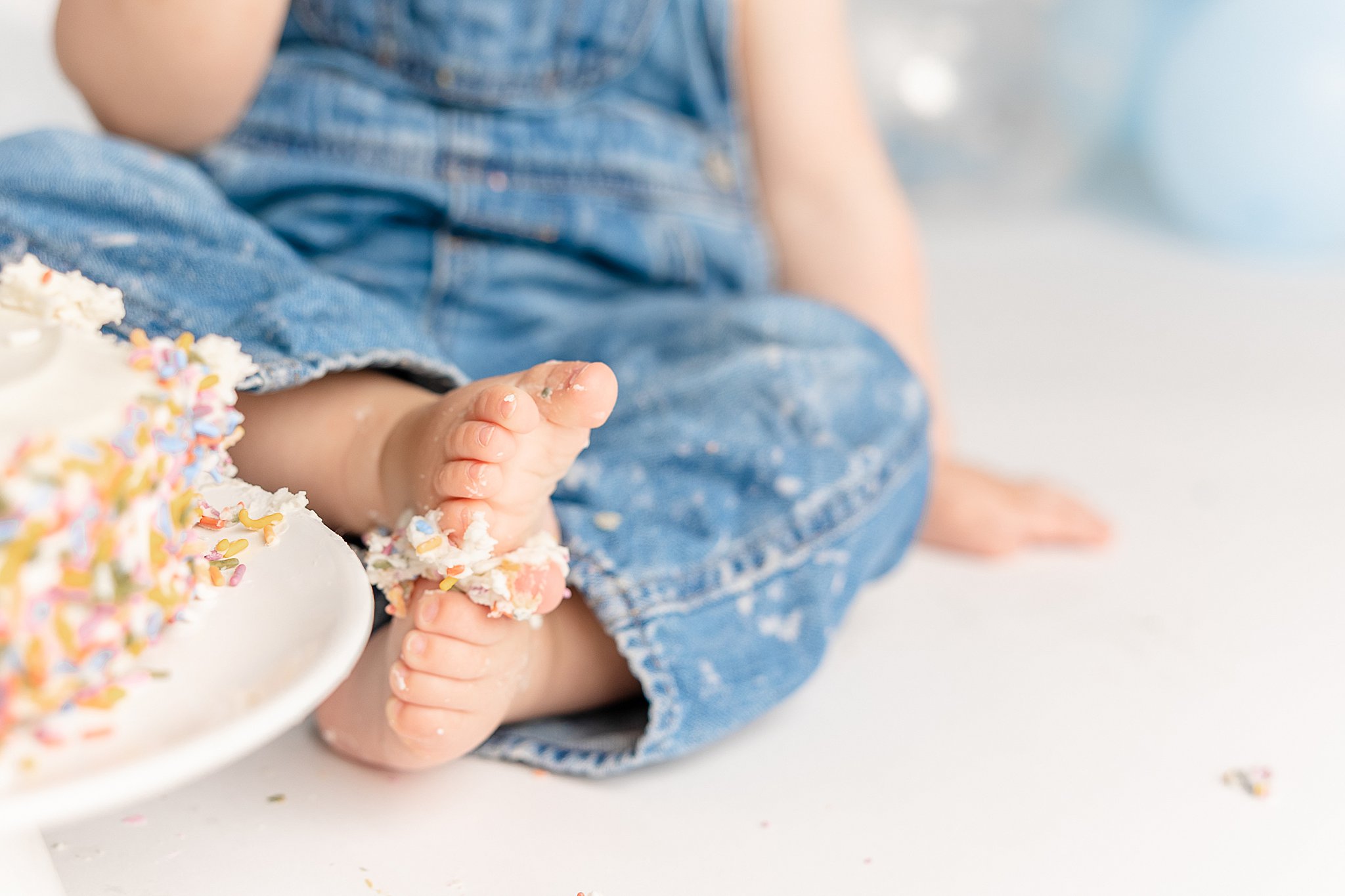 closeup of a one year old's feet covered in cake