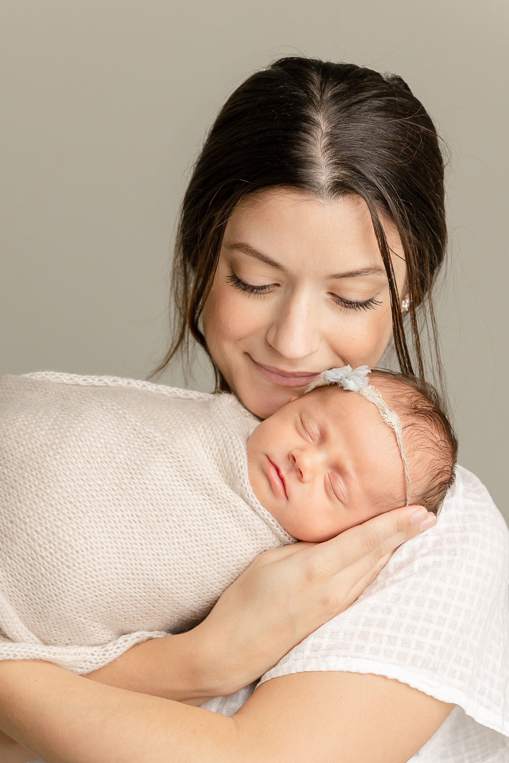 new mom holding her newborn baby girl PDX Doulas
