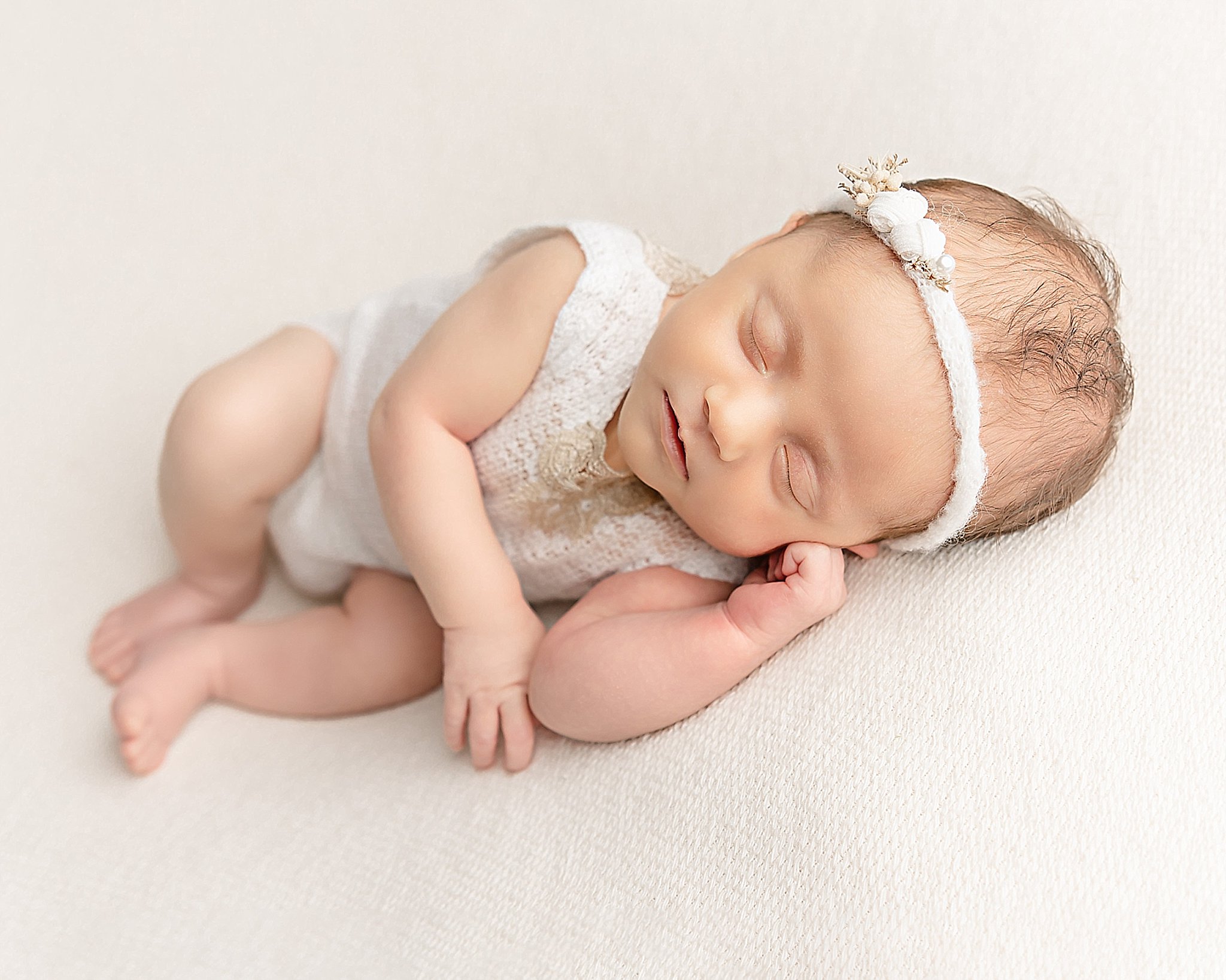 newborn baby girl in white outfit and headband Portland Lactation Consultant