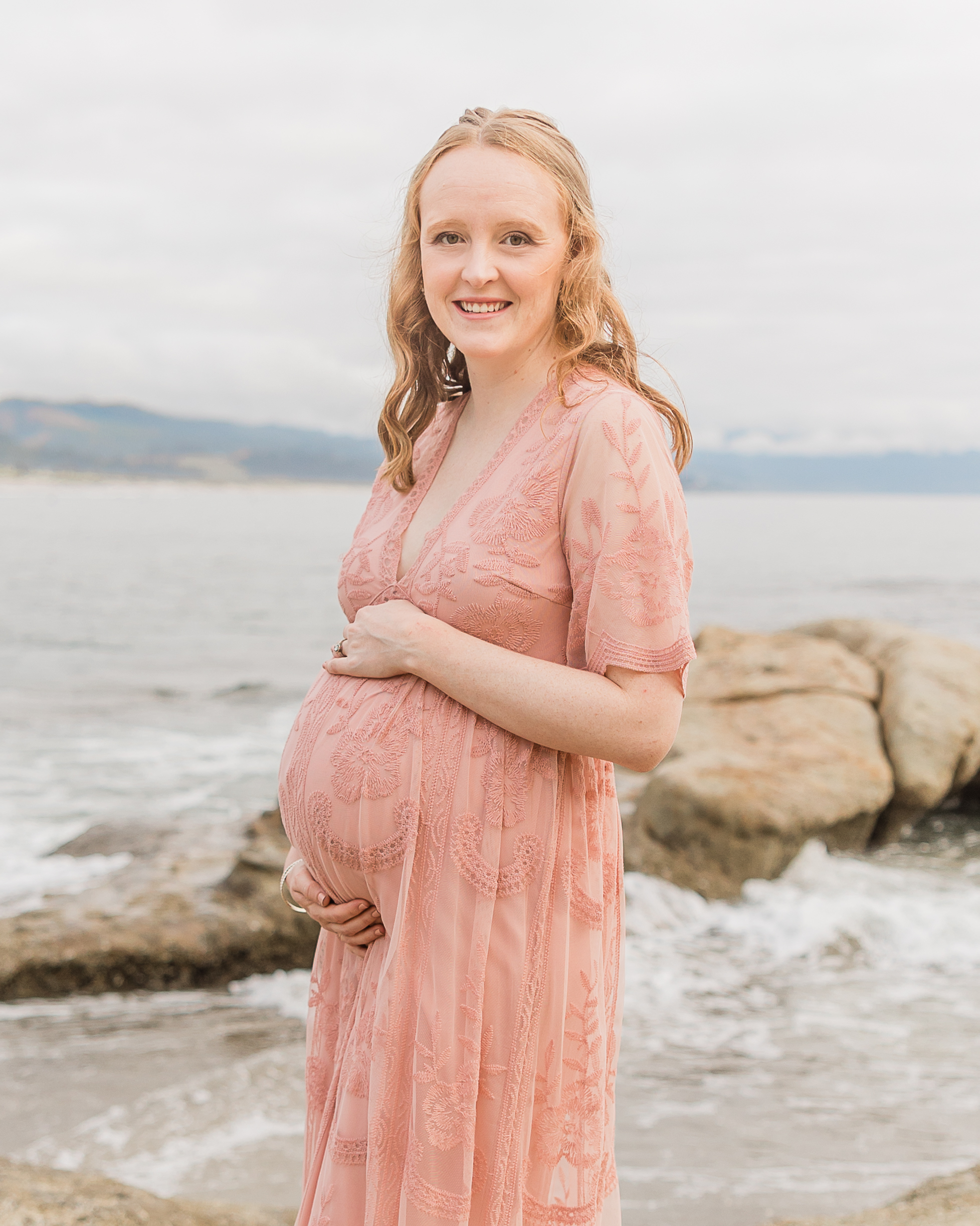 mom to be in pink maternity dress Portland Prenatal Massage